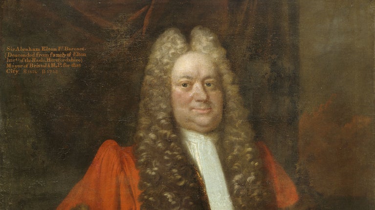ADetail of a oil on canvas portrait of Sir Abraham Elton as a stout elderly man, turned slightly to the right, gazing at the spectator, in a long full-bottomed wig, and wearing scarlet mayoral robes and a long white stock. A large dark-red drape in the background bears the inscription. He was the second son of Isaac Elton and Elizabeth (?); married Mary Jefferies, daughter of Robert Jefferies As a wealthy Bristol merchant he bought Clevedon Court and land around Clevedon.